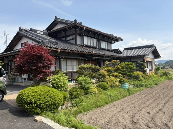 青空と緑に囲まれた、ひととワークスの建物外観